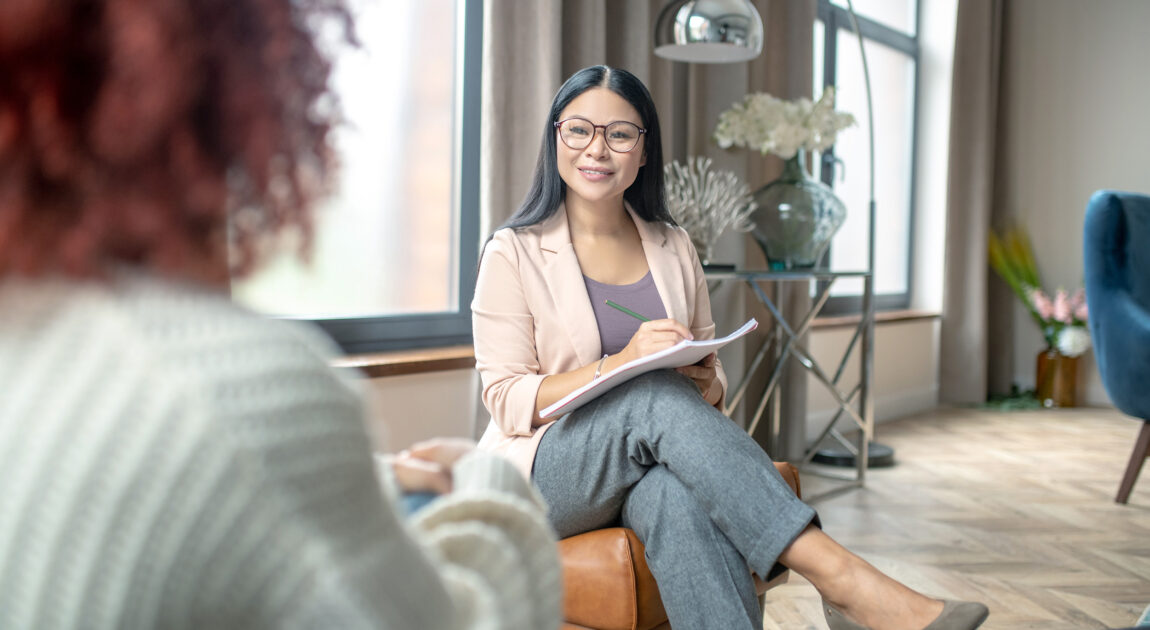 Female therapist in Toronto smiling during session—representing compassionate care and client connection