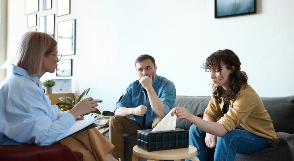 Psychotherapist talking to couple in Toronto at session for working through communication barriers in a safe space.