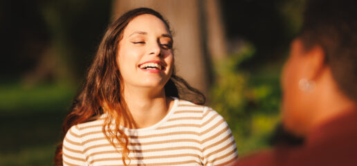 Young woman smiling in sunlight—symbolizing confidence and emotional renewal through therapy in Toronto