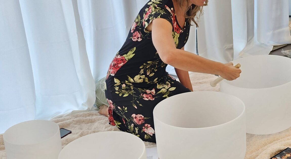 image of psychotherapist and sound practitioner using crystal sound bowls to help with anxiety, sleep and nervous system dysregulation in vaughan